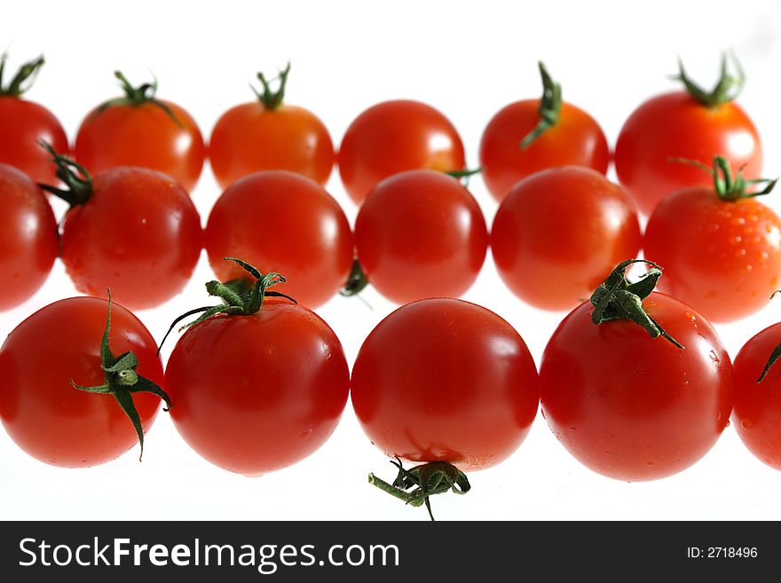 Three row of wet Cherry tomato on white. soft focus.