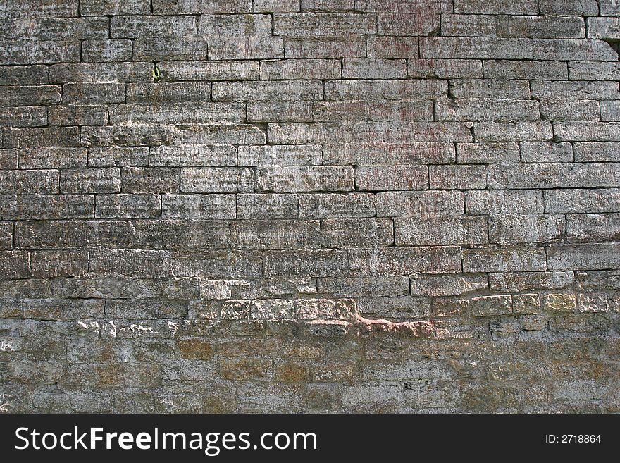 Obsolete castle brick wall as textured background. Obsolete castle brick wall as textured background