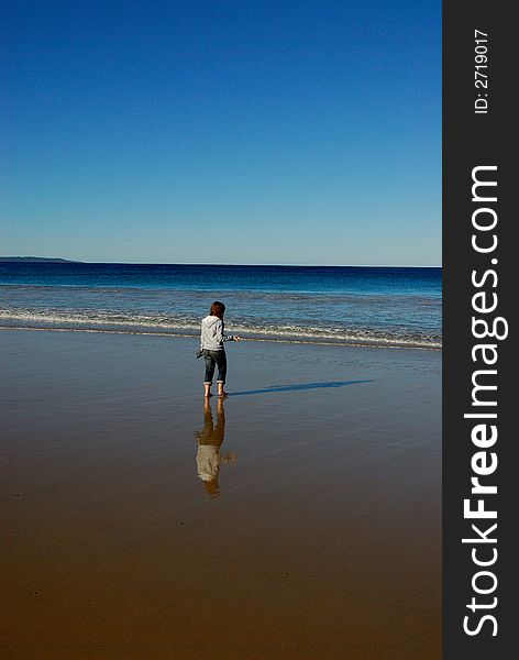 Picture of a girl looking out into the ocean. Picture of a girl looking out into the ocean