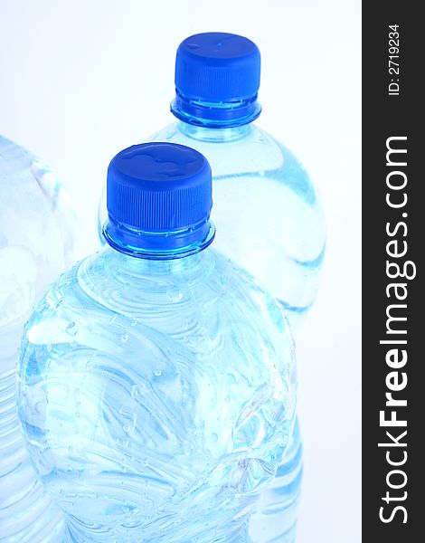 Mineral water pouring from a blue bottle