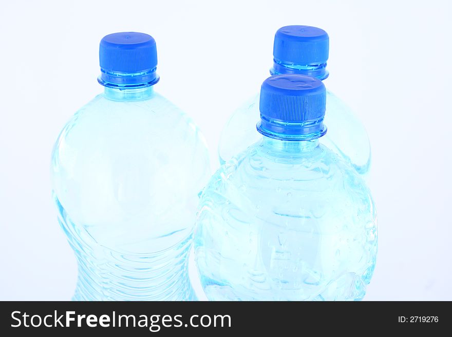 Mineral water pouring from a blue bottle