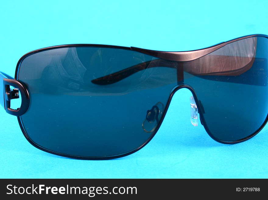 Sunglasses with tinted lenses on white