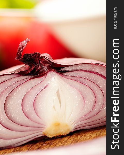 Red onion, sliced in half with vegetable on background. Red onion, sliced in half with vegetable on background