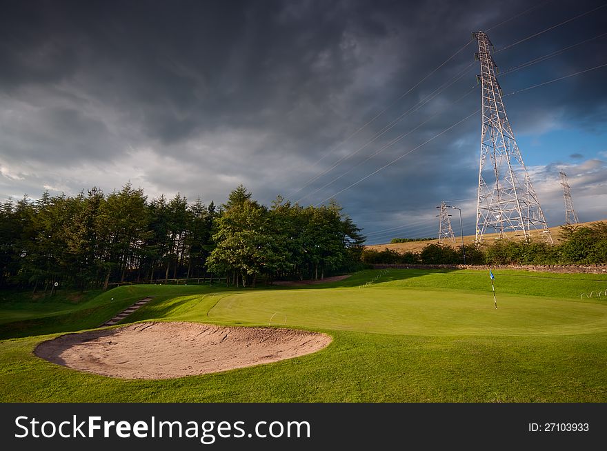 Ashton Under Lyne gold club near Manchester. In view is a green of golf course with a sand pit. Image no 122.