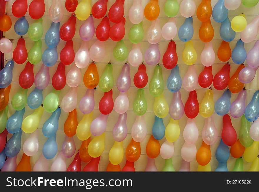 Colorful balloons on wall.