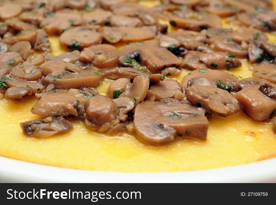 Closeup of polenta served with mushrooms and parsley. Closeup of polenta served with mushrooms and parsley