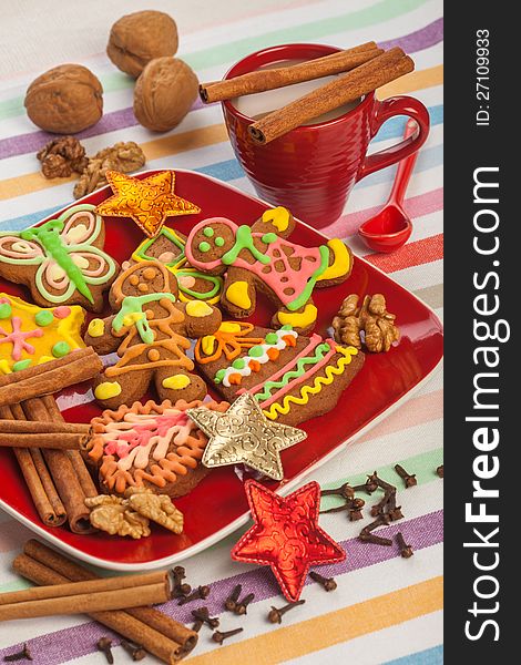 Gingerbread on a red plate, cinnamon, Christmas cookies. Gingerbread on a red plate, cinnamon, Christmas cookies