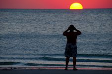 Man Photographing A Colorful Ocean Sunset Royalty Free Stock Images Man Photographing A Colorful Ocean Sunset Royalty Free Stock Images