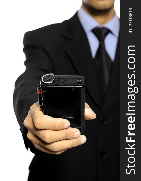 Businessman speaking into a dictaphone recorder over white background. Businessman speaking into a dictaphone recorder over white background