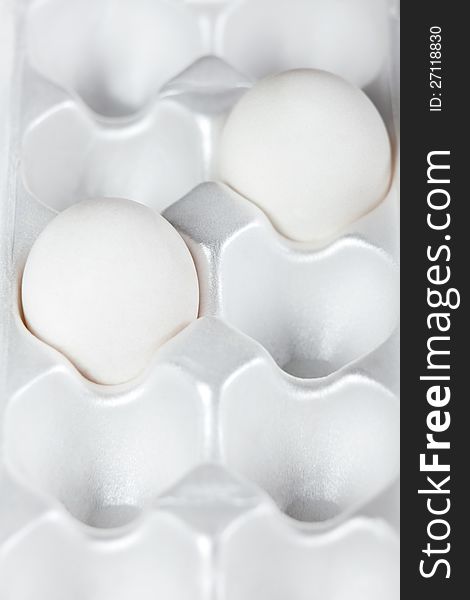 Two white eggs in packing for storage. Two white eggs in packing for storage