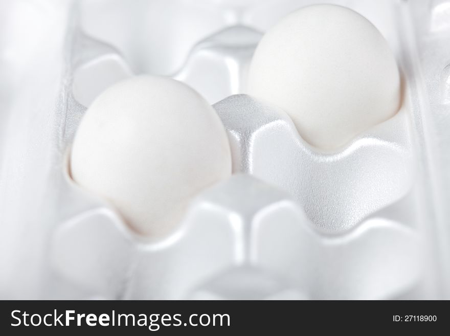 Two white eggs in packing for storage. Two white eggs in packing for storage