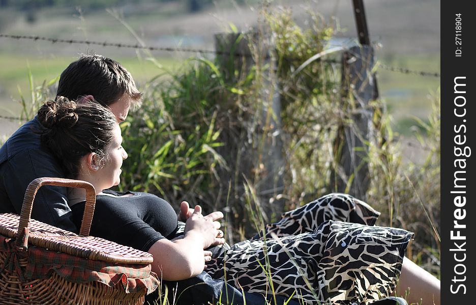 Romantic Young Couple Having Picnic In Countryside