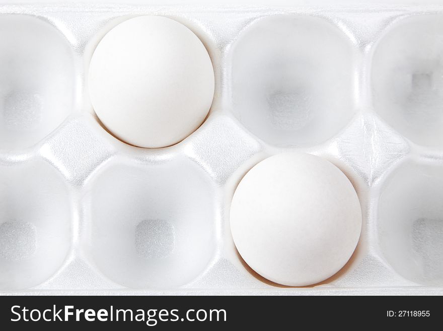 Two white eggs in packing for storage. Two white eggs in packing for storage