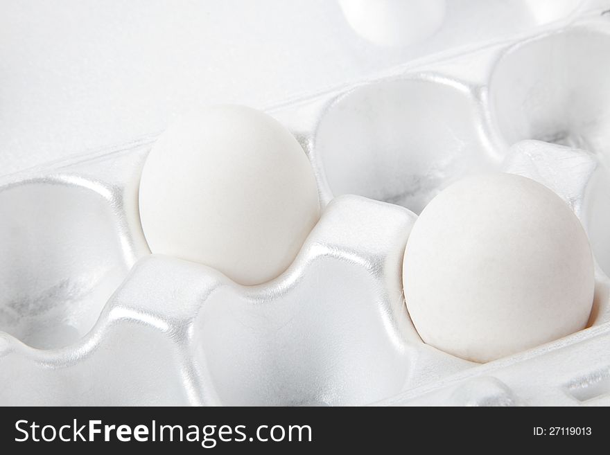 Two white eggs in packing for storage. Two white eggs in packing for storage