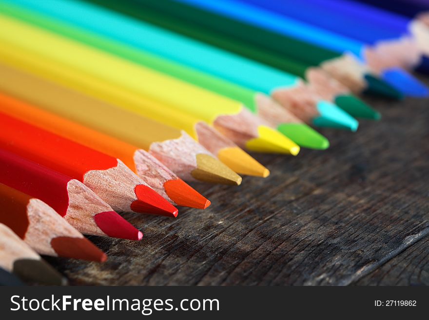 Set of color pencils on old wooden surface. Set of color pencils on old wooden surface