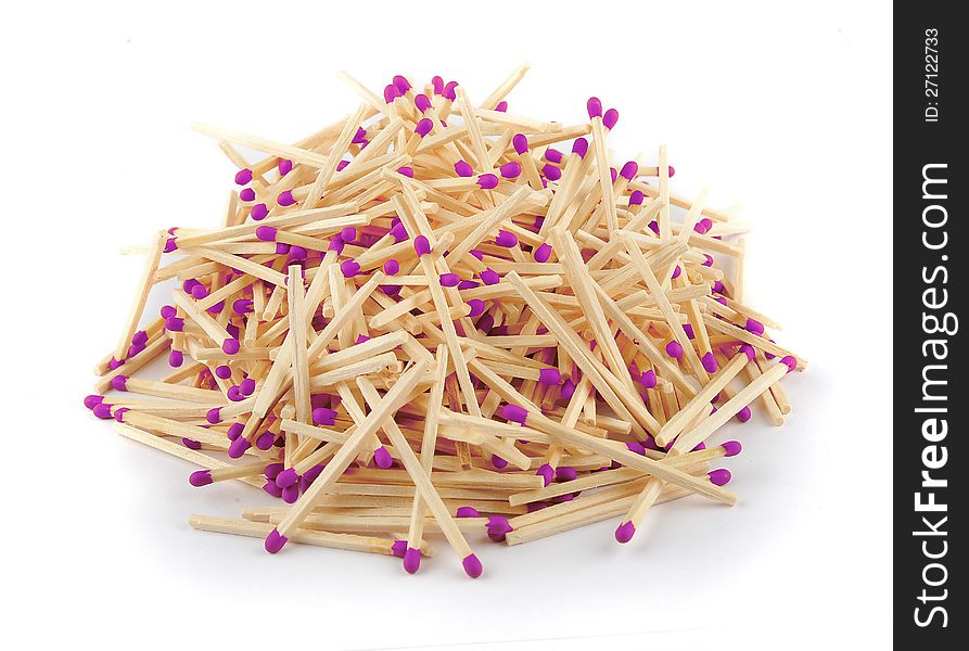 A pile of matches in with purple tips isolated on a white background. A pile of matches in with purple tips isolated on a white background