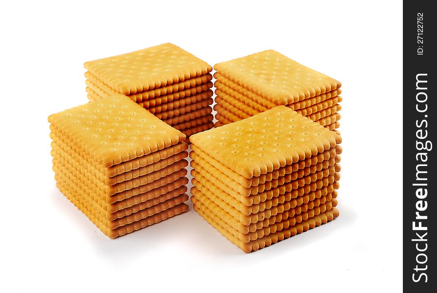 Four stacks of tea biscuits arranged in a cross isolated on a white background. Four stacks of tea biscuits arranged in a cross isolated on a white background