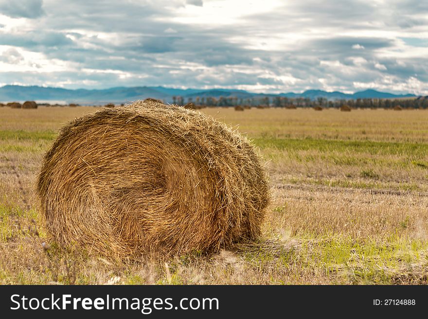 Haystack on a background of mountains in October