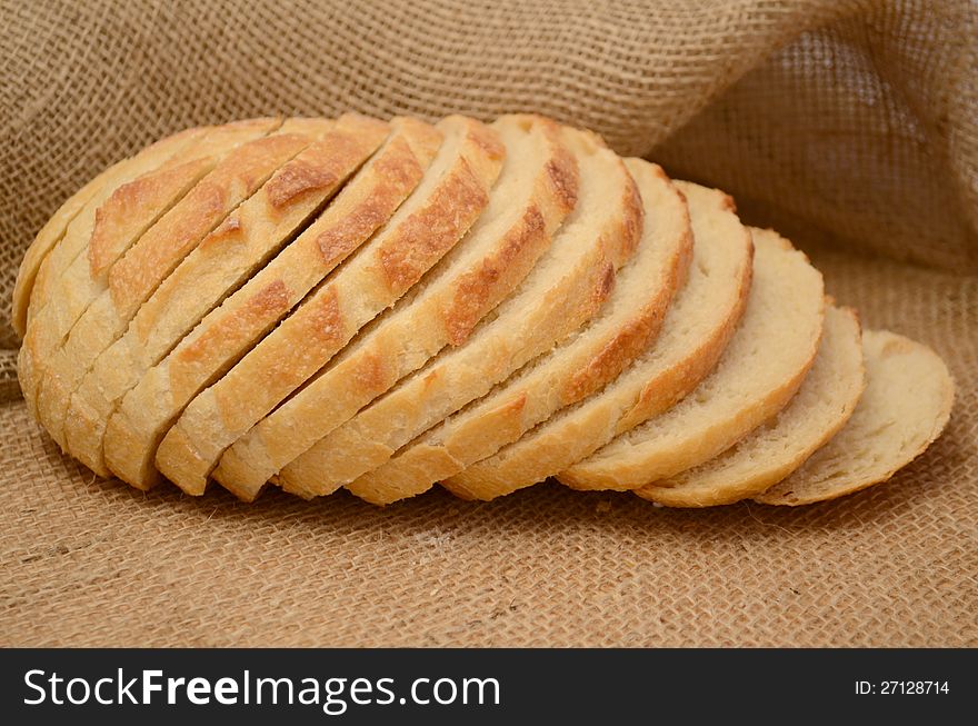 Sliced round bread on burlap.