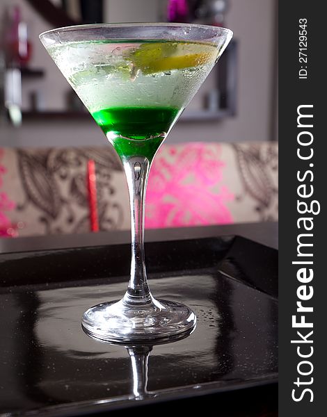 Brightly lighted and colorful Martini cocktails with lemon. Brightly lighted and colorful Martini cocktails with lemon