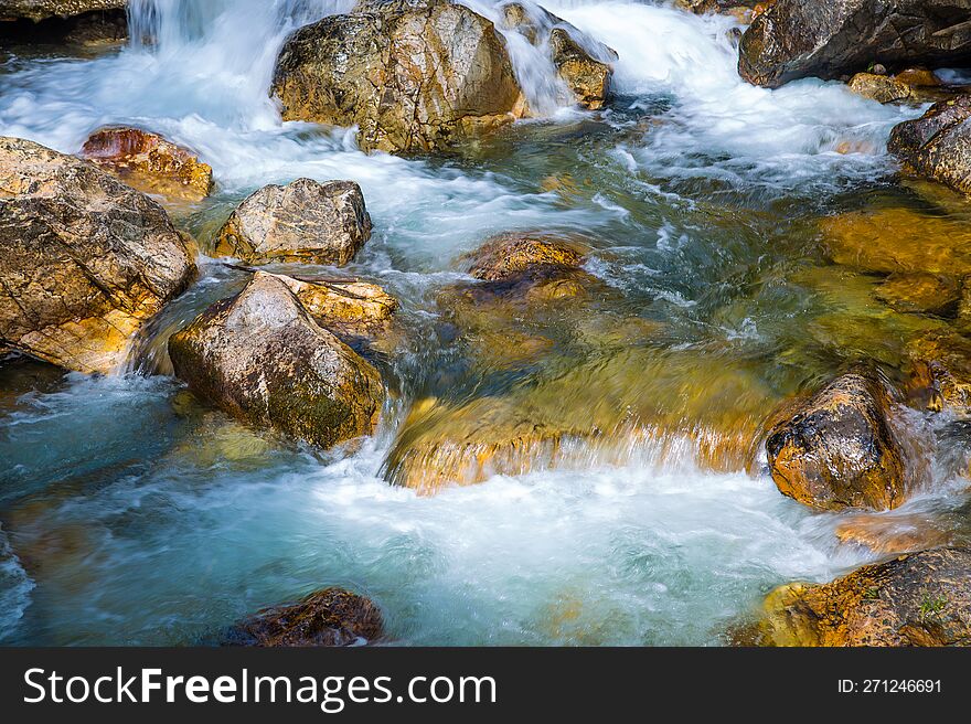 Flowing water in river through the rocks