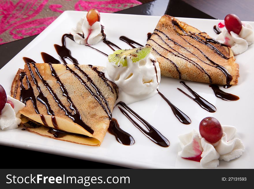 Pancakes with ice cream & chocolate souse on white plate. Pancakes with ice cream & chocolate souse on white plate