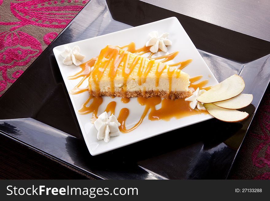Fresh cheese cake with caramel syrup and piece of apple. Fresh cheese cake with caramel syrup and piece of apple
