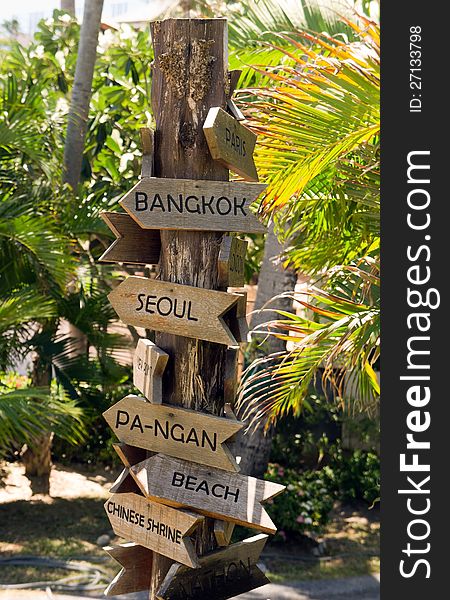 Signpost with arrows on the tropical beach