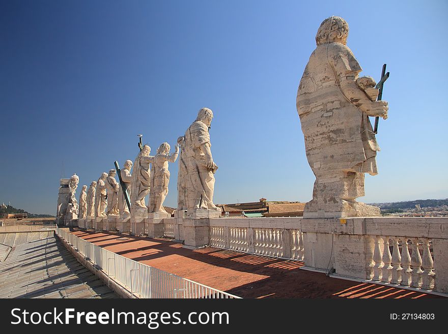 Statues of Jesus and apostles on saint Peter's cathedral roof in Vaticano