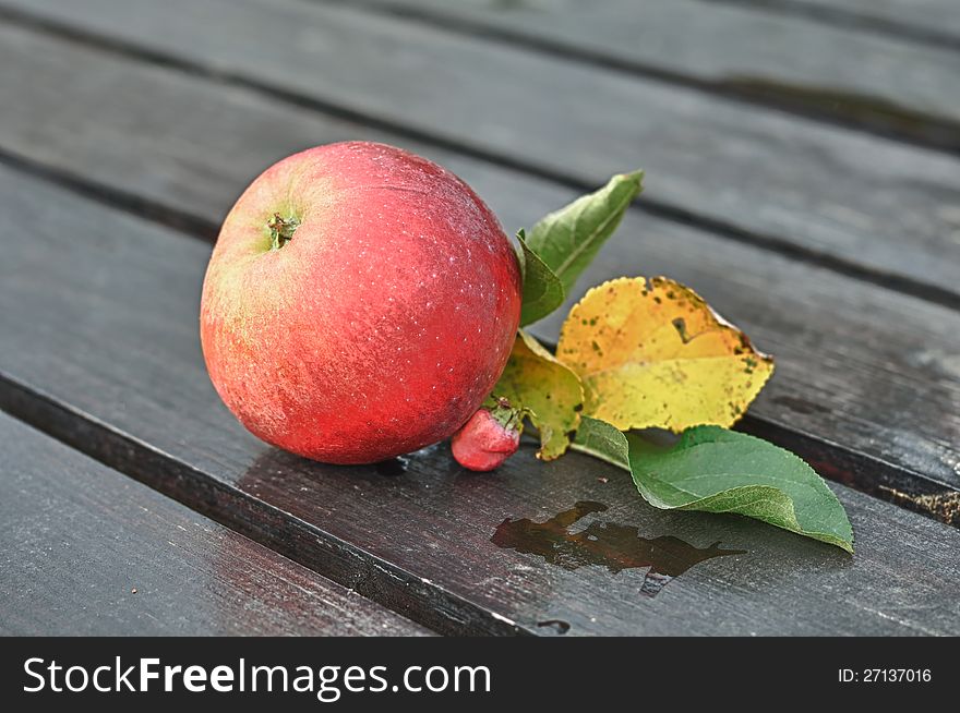 Red Apple with Leaves on Wooden Table