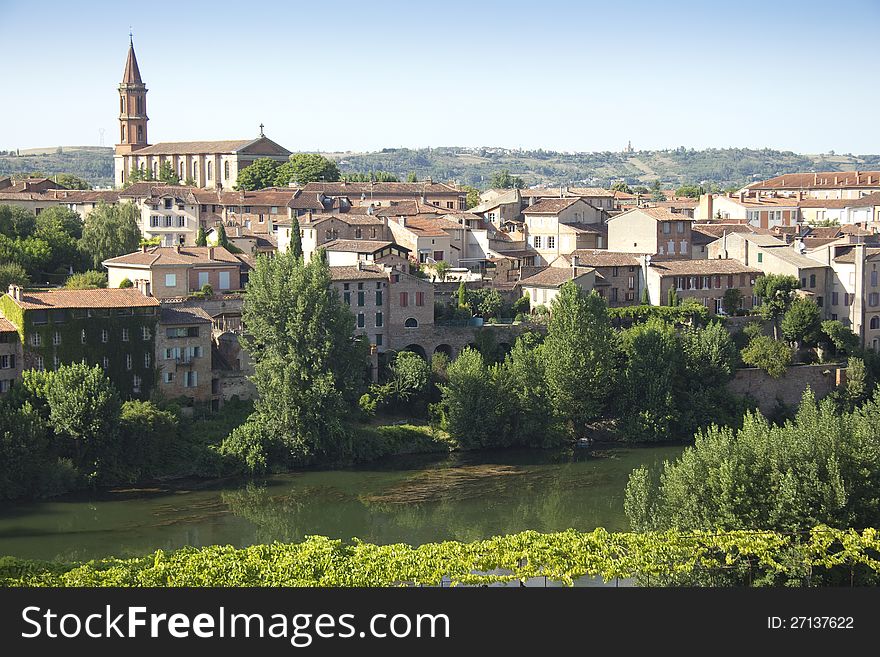 View over the river Tarn towards St-Madeleine Church in the commune in southern France. View over the river Tarn towards St-Madeleine Church in the commune in southern France