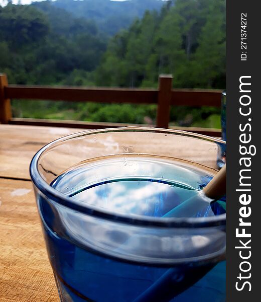 enjoy morning on top of hill with green trees view with blue drink