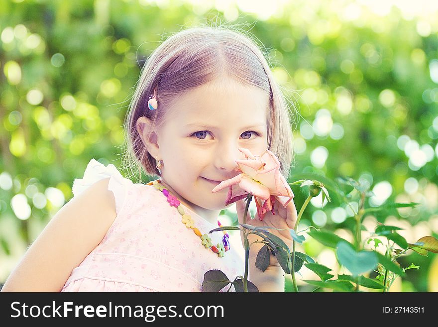 Portrait of a cute little girl smelling a flower. Portrait of a cute little girl smelling a flower