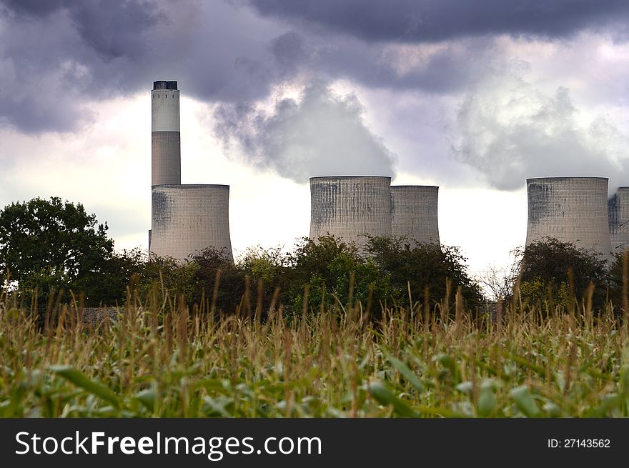 Environmentally non-friendly coal-fired power station in the East Midlands of the UK viewed from a rural perspective with dramatic overhead skies. Copy space.