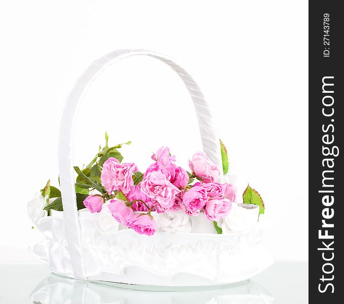 Beautiful pink roses in wedding basket on white background. Beautiful pink roses in wedding basket on white background