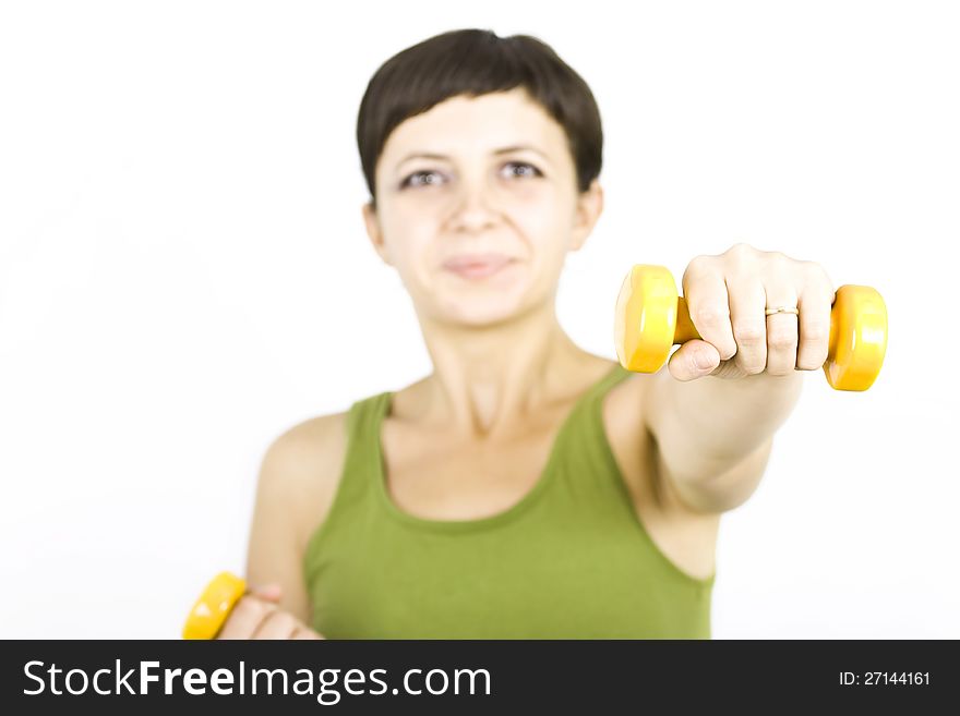 Happy young woman during fitness time and exercising lifting dumbbells. Happy young woman during fitness time and exercising lifting dumbbells