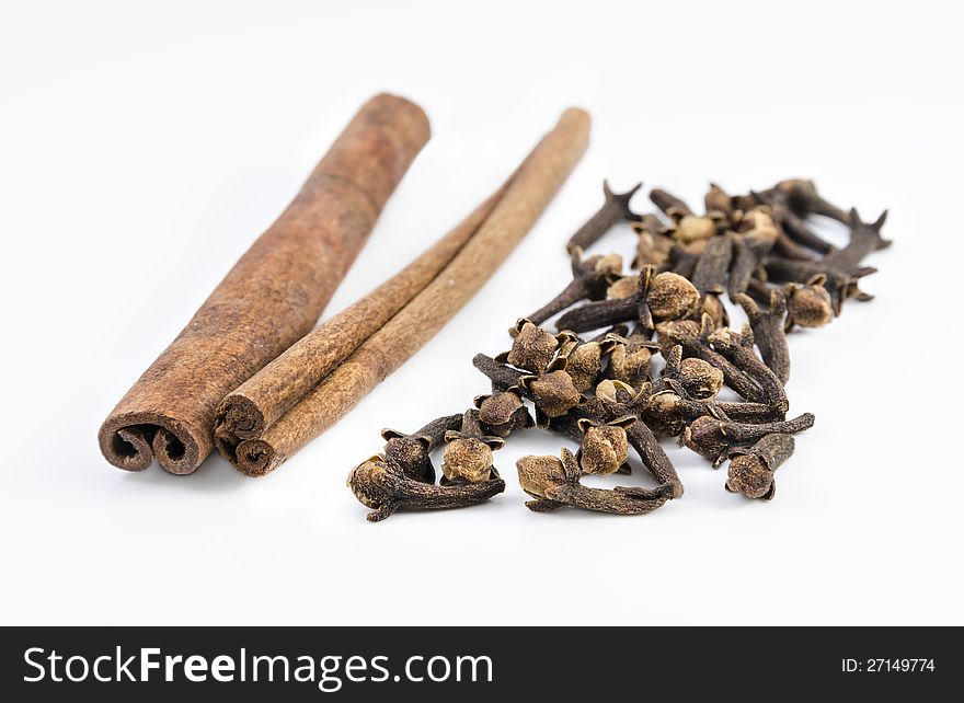 Nice shot of some food ingredients , cloves and cinnamon isolated on white background. Nice shot of some food ingredients , cloves and cinnamon isolated on white background