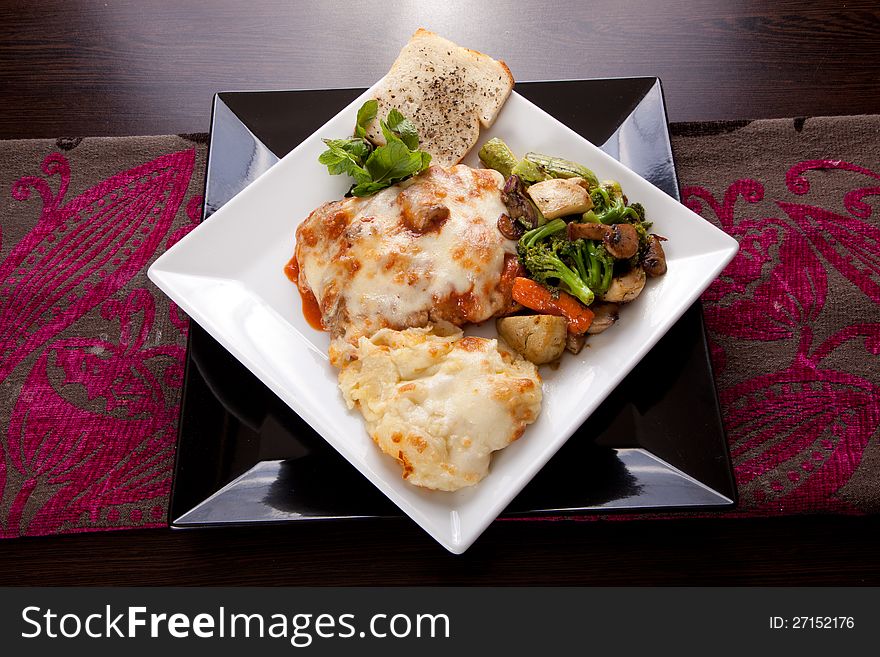 Italian Chicken with mozzarella cheese , mixed peppers, Vegetables , olive and Parmesan sauce