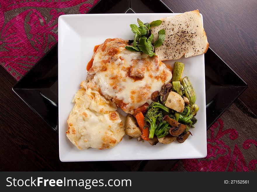 Italian Chicken with mozzarella cheese , mixed peppers, Vegetables , olive and Parmesan sauce