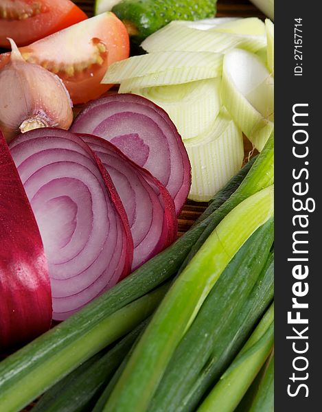 Red Onion and Various Vegetables with Leek, Garlic, Luttuce, Cucucmber and Tomatoes as background. Red Onion and Various Vegetables with Leek, Garlic, Luttuce, Cucucmber and Tomatoes as background