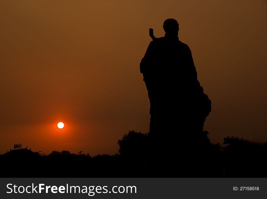 Sunset in the park, with a statue of famous artist (Qi Baishi )in China. Sunset in the park, with a statue of famous artist (Qi Baishi )in China