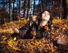 Young Woman Lying In Fallen Leaves Royalty Free Stock Photo