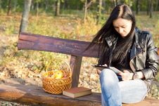 Woman On Park Bench Using A Tablet Stock Images Woman On Park Bench Using A Tablet Stock Images