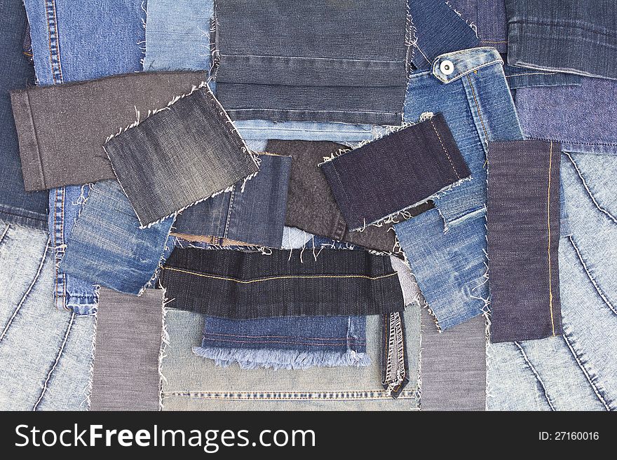 Background of overlapping pieces of denim.