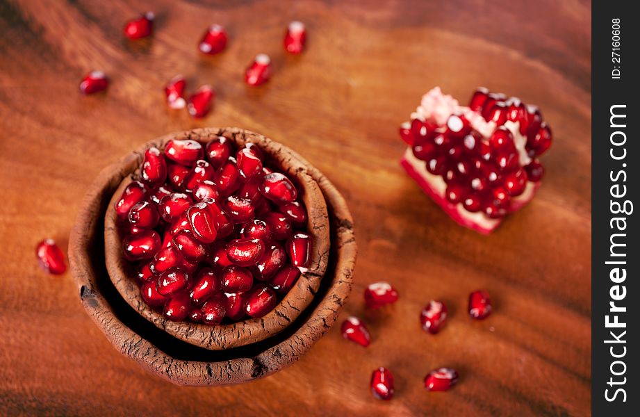 Ripe pomegranate grains in a ceramic bowl