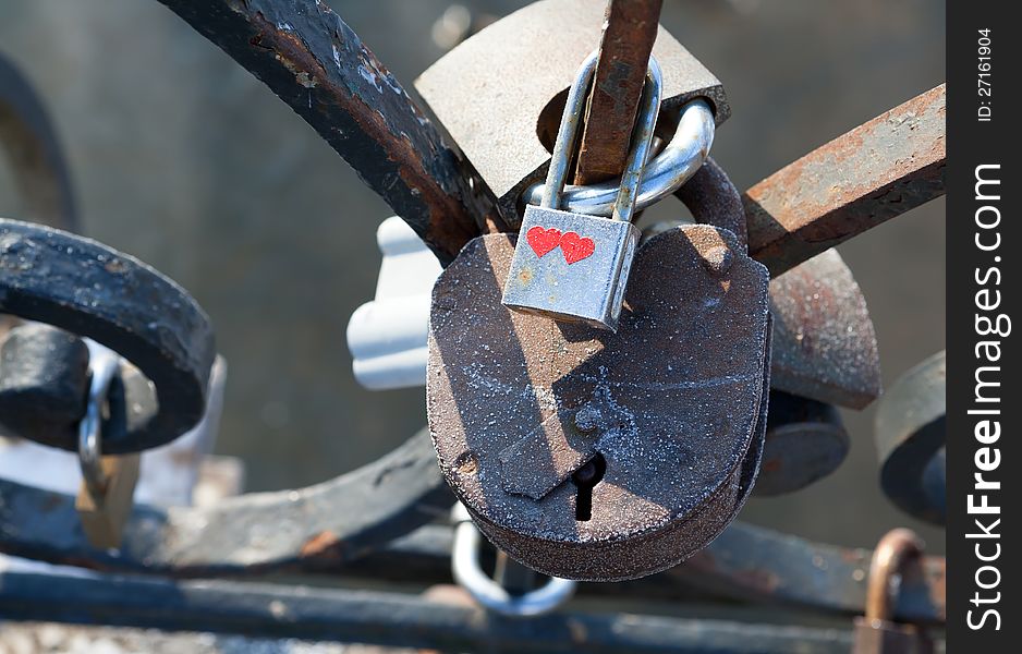 Love padlocks - symbol of eternal happiness.  Love padlocks hanging on the railing of the bridge