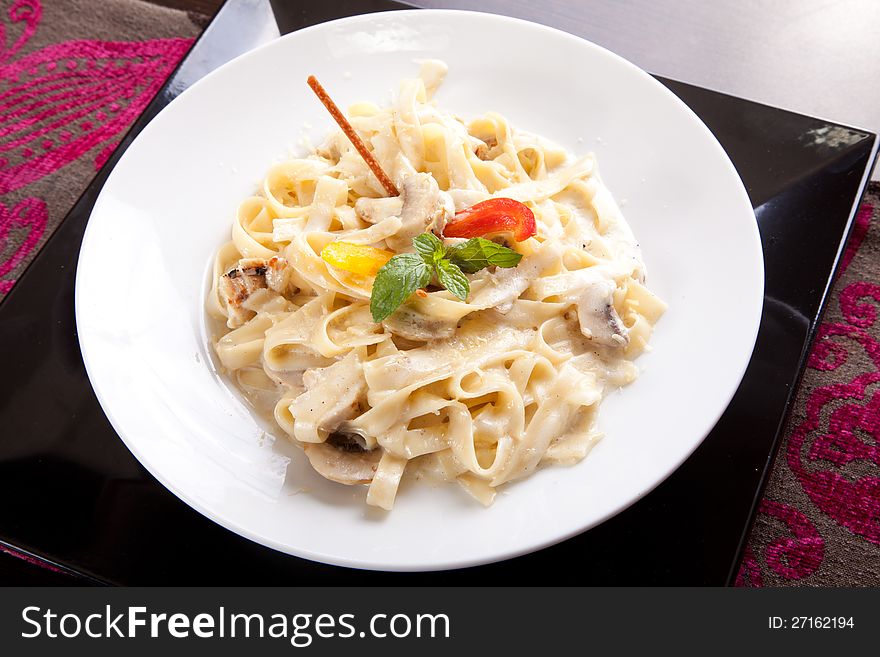 Tasty pasta with cream, cheese and parsley