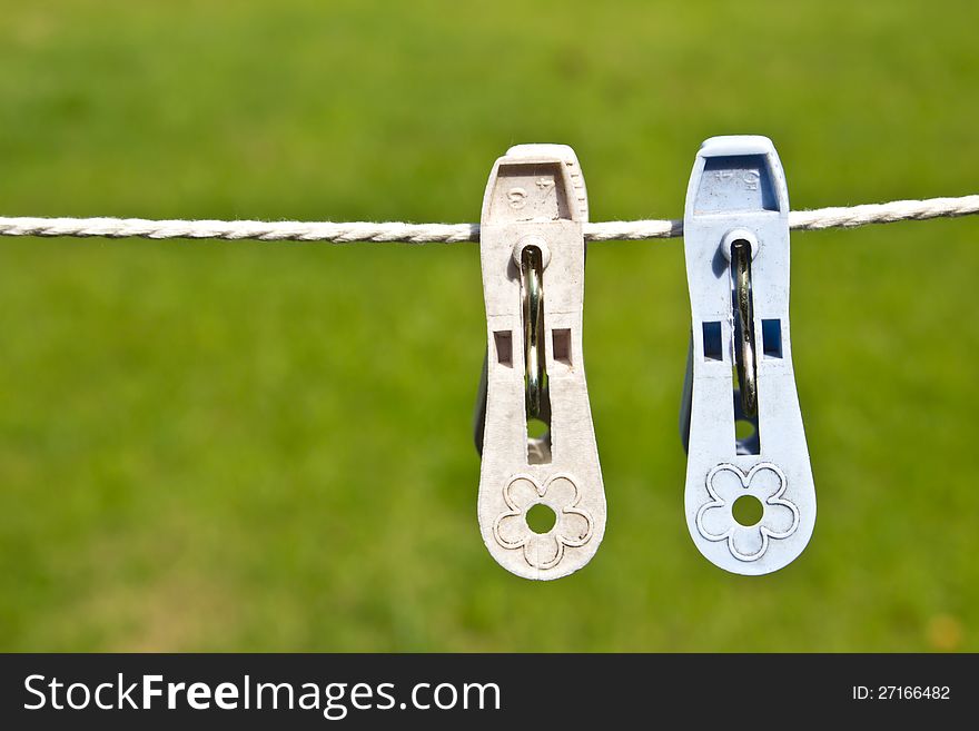 Colored clothespins on a green background. Colored clothespins on a green background