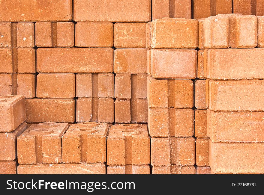 Common quality building bricks stacked ready for use.