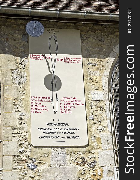 Old astronomical instrument on the wall of the church in a small French town. Old astronomical instrument on the wall of the church in a small French town.